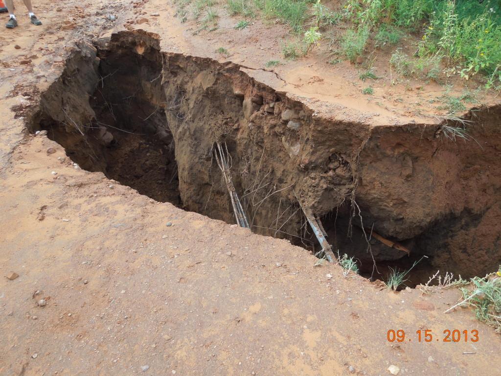 Washed out road reveals bare wires underneath
Photo by Matt Rivera