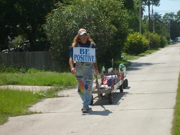Phillip Cargile pulls his string of wagons and is wearing his famous BE POSITIVE sign in his home town Panama City, Florida.