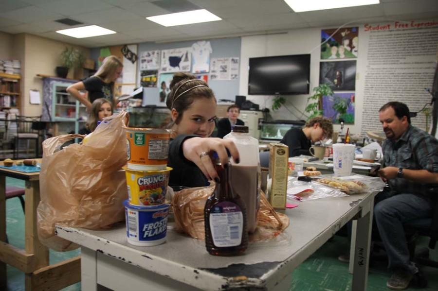 Jensen Delius (9) reaches for the syrup in Mr. Hilts first block, English 1 Honors. This class, which is comprised of seven students, has breakfast together every Wednesday and Friday. 
