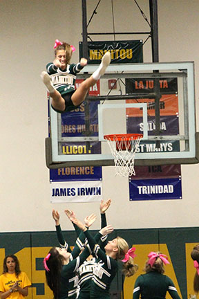 Cheer flyer Alyssa Price (11) gets some loft while Devon 
Arabia (12) and Kelsey Hartwig prepare a cradle for her landing. 