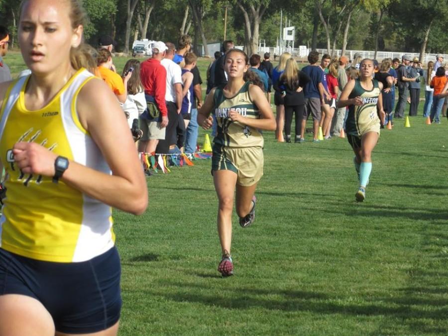 Brooklyn Mack (10) nudges out Jen Cole (11) in the final moments at the Tri Peak meet. Both girls ran in the low 21 minute range to lead the team to a second place league title.