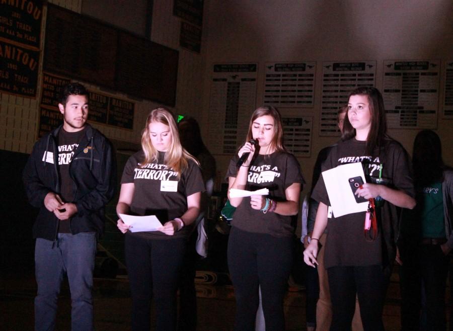 Palmer students present their lines in the dark gym. 