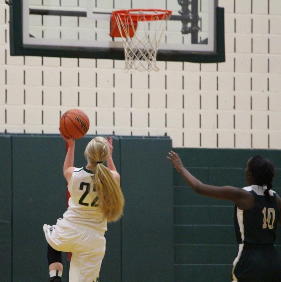 Maddie Frahm (11) scores a layup after a Mustang fast break. Frahm was instrumental against Manitous win against Machebuef scoring double digits.
