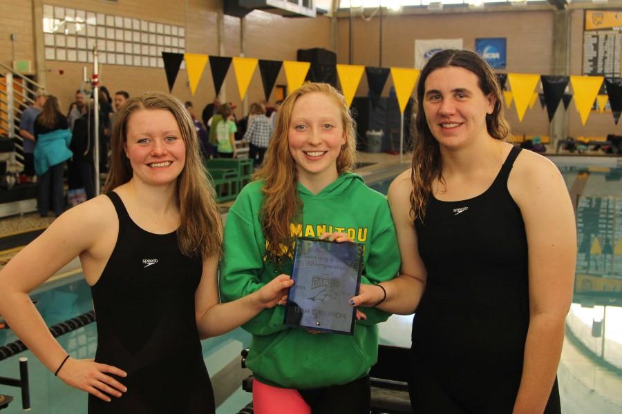Team captains Samantha White (12), Veronica Morin (12) and Carrie Linhart (12) hold their team championship plaque. All three captains have swam competitively for years. 