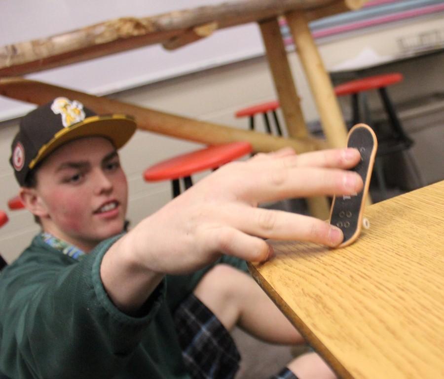Devin Kelly (12) playing with the currently popular Tech Deck during a break in a French class. These Tech Decks are making a comeback here at Manitou after a long break in popularity. 