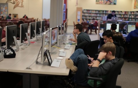 Students work in the media center during fourth block