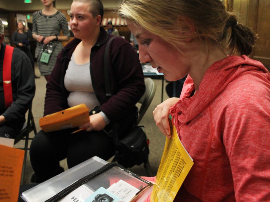 Maddie Butts (11) receives her envelope for Urban Peaks poverty simulation. Included in the envelope were things such as a fake social security card, a retirement check, and a list of guidelines for the simulations. Throughout the simulation, Butts completed tasks such as applying for a loan and trying to acquire health insurance.