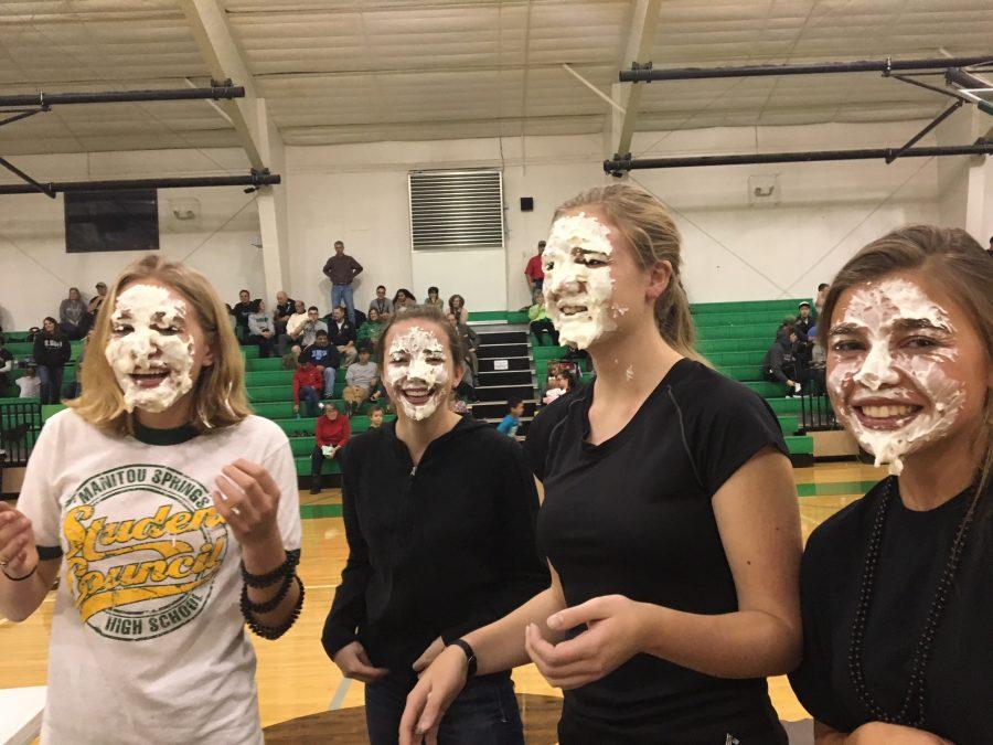 (from left to right) Sage Stevens (11), Andrea Edwards (12), Amelia Mackenzie (12), and Kaitlyn Davidson (11) laugh after having been pied in the face by SMHS council members. Stevens and Davidson were filling in for the executive board members and other seniors who were unable to make it to the game.
