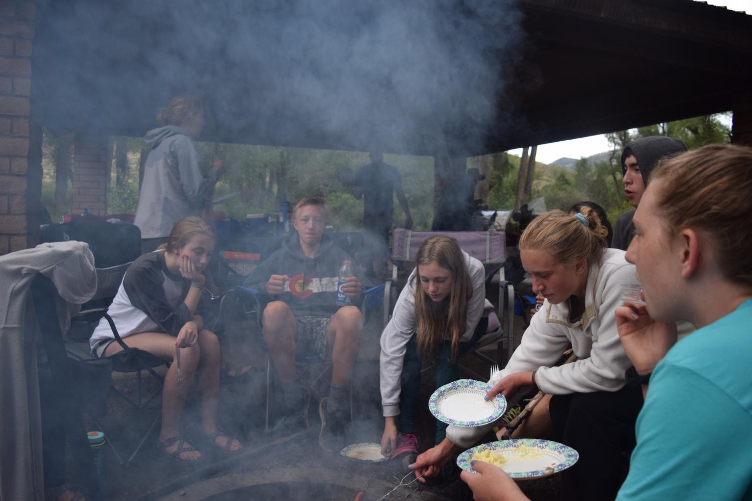Lizzy Butts (10), Parker Hall (10), Mia Heiniger (9), Jayden Omi (11), Sage Stevens (12) and Coco Stevens (10) gather around a fire to converse and cook hot dogs in the evening. The (StuCo) retreat was an incredible opportunity to get to know each other, Sage Stevens said. 