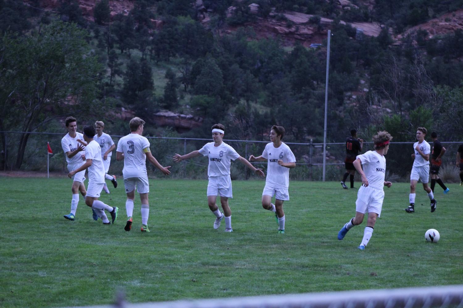Riley Jungbauer (10) celebrates with his teammates after scoring one of his three goals in the game against Lamar resulting in a hat trick. Jungbauer was on the varsity team his freshman year and is on it again this year, making it his second year of soccer with the high school. 