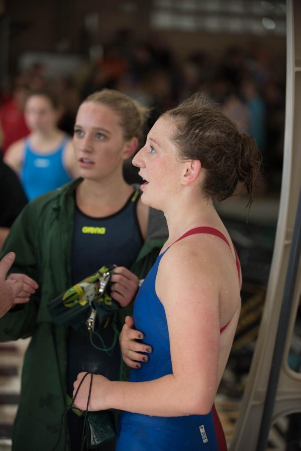 The two sisters-- Sage (12, left) and Coco (10, right) Stevens-- talk to their coach fresh out of the pool after racing each other in the 50 free at Leagues. This was the second day in a row that Sage got the state cut, and the first time in an individual event that Coco broke the 25 seconds, securing herself a Sectionals cut. 