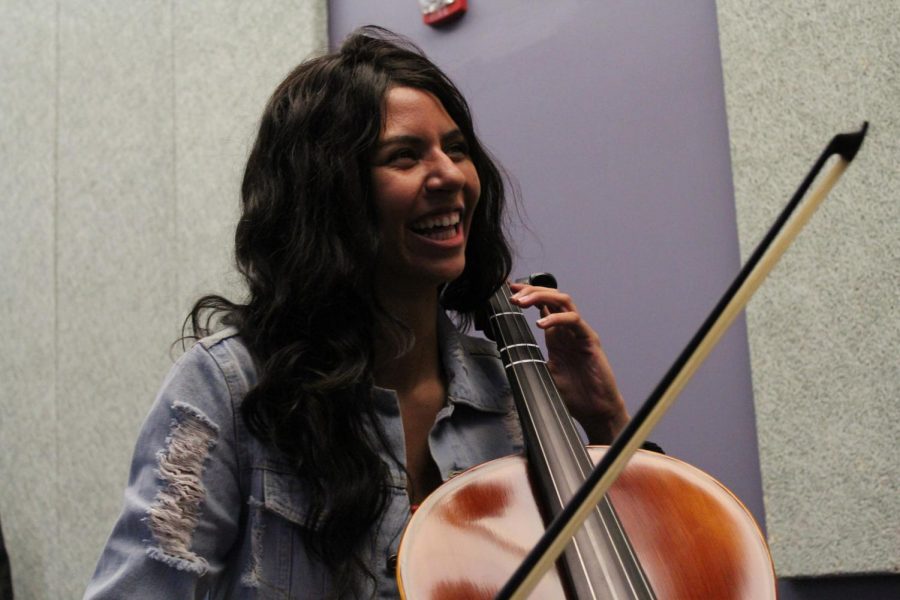 Talia Traxler (11) laughs after finishing a scale on her cello.