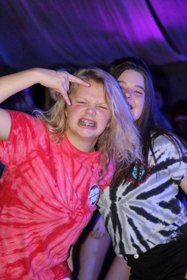 Grace Olson (10) throws up a Rock On sign as she dances with her close friend Mady Caywood (11). The two have gone to every dance this year and were happy to be supporting such a good cause. 
