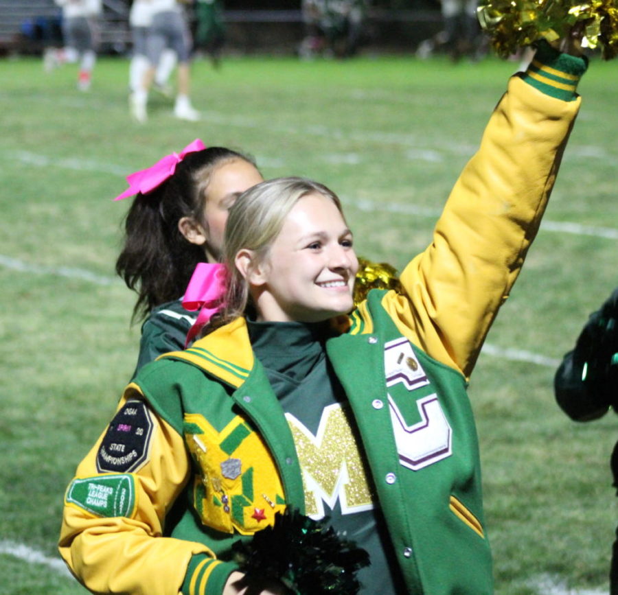 Cheer captain, Weatherly Hall (12), leads the cheer team at during the Homecoming football game.
