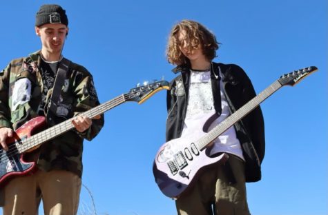 Lucas Grieb (12) & Lance Warner (12) pose for a band photo, outside in Manitou Springs, CO, with their guitars. 