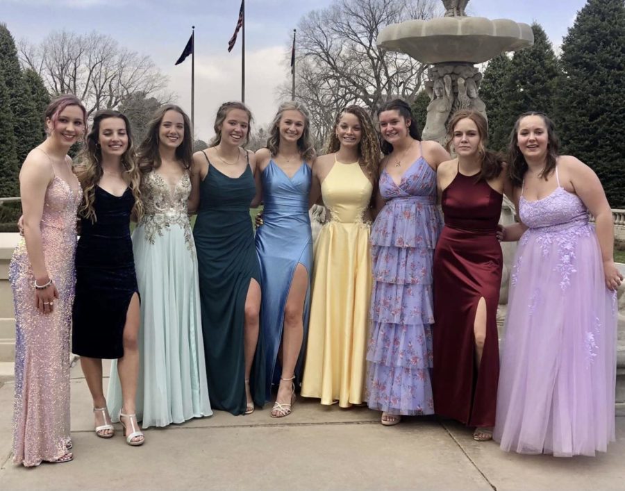 Aiden Coté, Ashley Magee, Kylie Matas, Abigail Parker, Weatherly Hall, Alexia Vigil, Skylar Stanley, Ayla Lehner, and Macey LaSarre getting pictures taken with their friends at the Broadmoor for the 2022 prom dance.