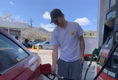 Logan Smith (12) fills up his car at the Loaf and Jug on Manitou Ave.