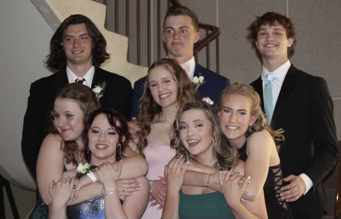Anthony Snow, Amelia Hamilton, Camden Seal, Parker Salladay, Hailey Huyser, Riley Battig,  Nick Downing and Charlotte Anderson take pictures together before the 2022 prom dance.