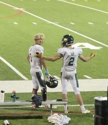 Tyler Maloney #5 and Evan Scherr #2 after scoring a combined 5 touchdowns on the sideline after winning 46-12 against Rocky Ford High School.