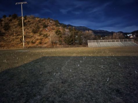The Manitou Springs High Schools football field being forked by Woodland Park High School students before a basketball game in 2021.