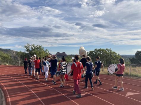 The MSHS Symphonic Band plays the Fight Song as they round the track.  The band practices for the parade every year.
