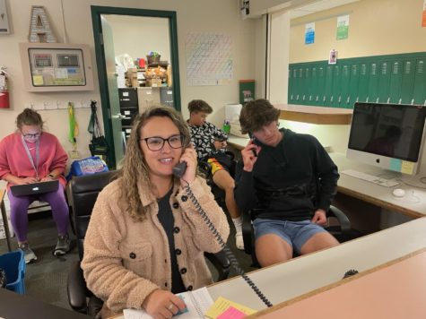 Stacy Thomson, current Administrative Assistant, and Andrew Rhodes (12) answer the phones in the front office on one of Thomsons first days back.