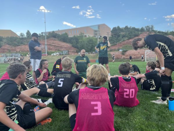 Manitou Springs High School varsity soccer team huddles at half time on Aug. 3 to discuss their gameplay. The team won their last two games and continued on strong with a winning score of 10-0.