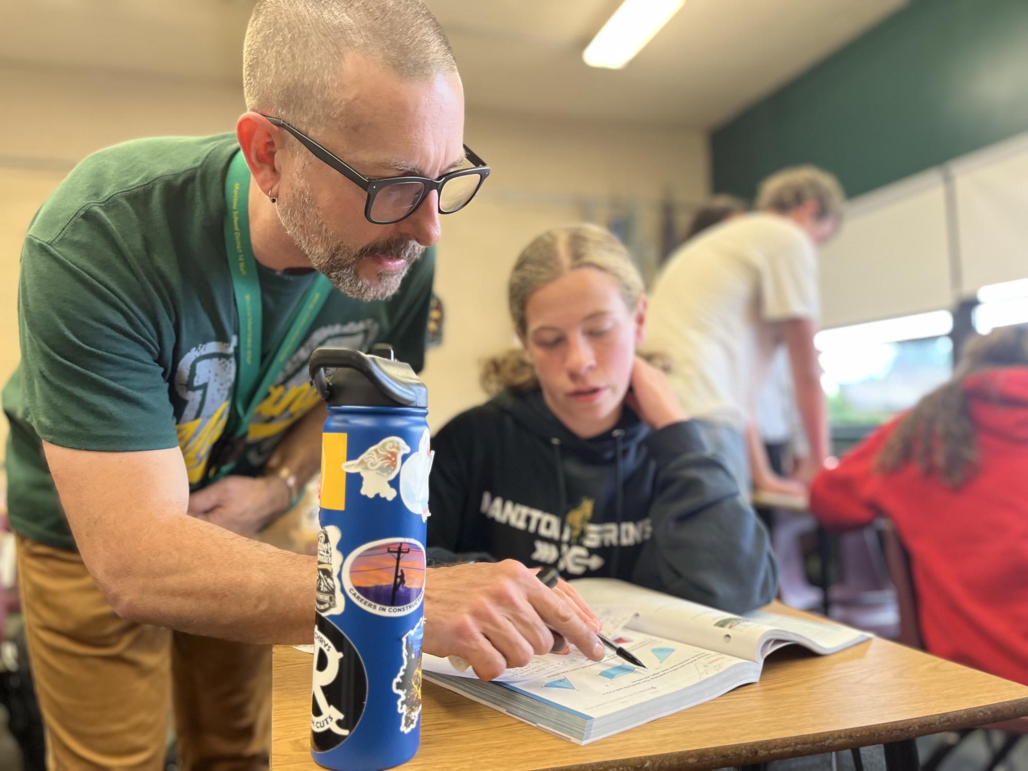 Substitute teacher Jon Murphy helps Rylynne Murphy in his Geometry class on Sept. 15. Murphy had been part time substitute teaching at MSHS since February of 2001 and recently stepped in to take on a full time position, co-teaching with Erich Hoffmann.
