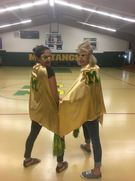 Angie Glass and Wendy Skokan dress as super heroes for a student assembly in 2019.  During her time at MSHS, Glass was the true embodiment of a Mustang, just like Skokan, who is also a former administrative assistant. 
