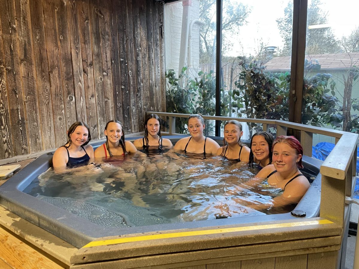 The girls swim team hangs out in the hot tub at the Manitou Springs Pool after a hard practice. This Thursday was the very last pre-season practice before the official season starts.