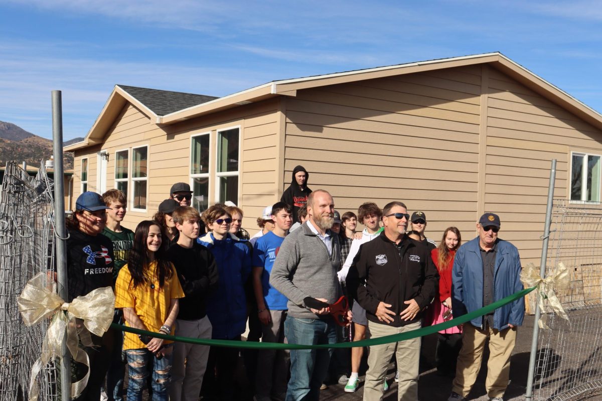 Teacher of the Careers in Construction class, Brad Borkowski, and his students prepare to open the house build to those in attendance of the unveiling.