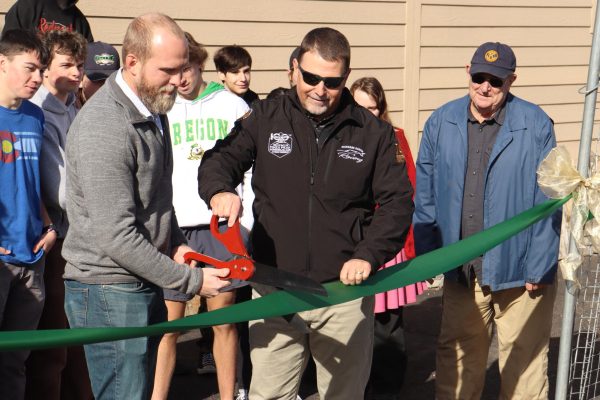 Glenn Hard and Brad Borkowski cut the ribbon alongside construction students on Thursday, Nov. 30.