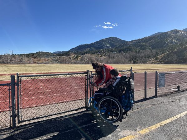 Paraprofessional Talor Goodloe, takes Austin Durham (10) out of class early to make it through the only wheelchair accessible gate before scheduled fire drill.