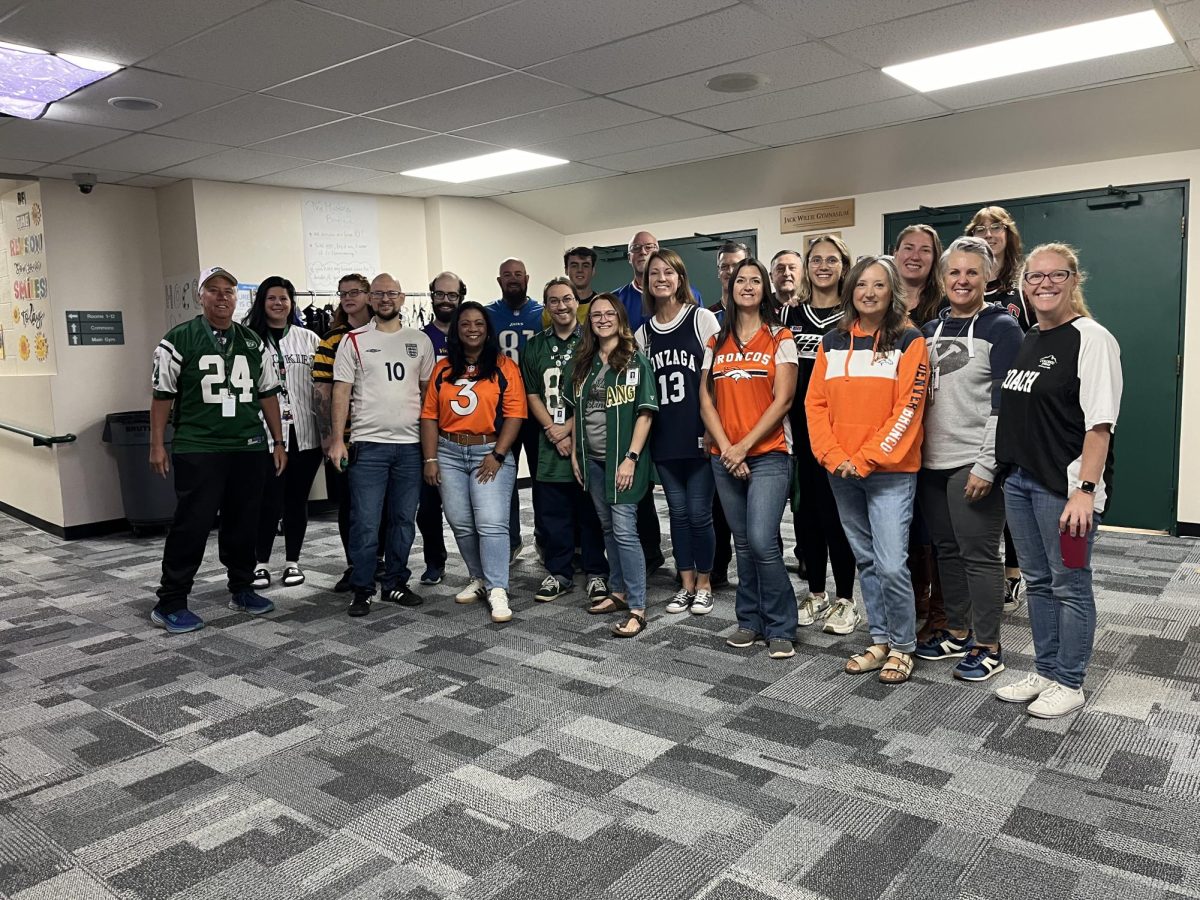 The MSHS staff poses together in their jerseys of choice for homecoming spirit week on Monday Sept 23. "It's great school spirit, and it influences others to dress up as well," front office secretary Cat Albanese said.