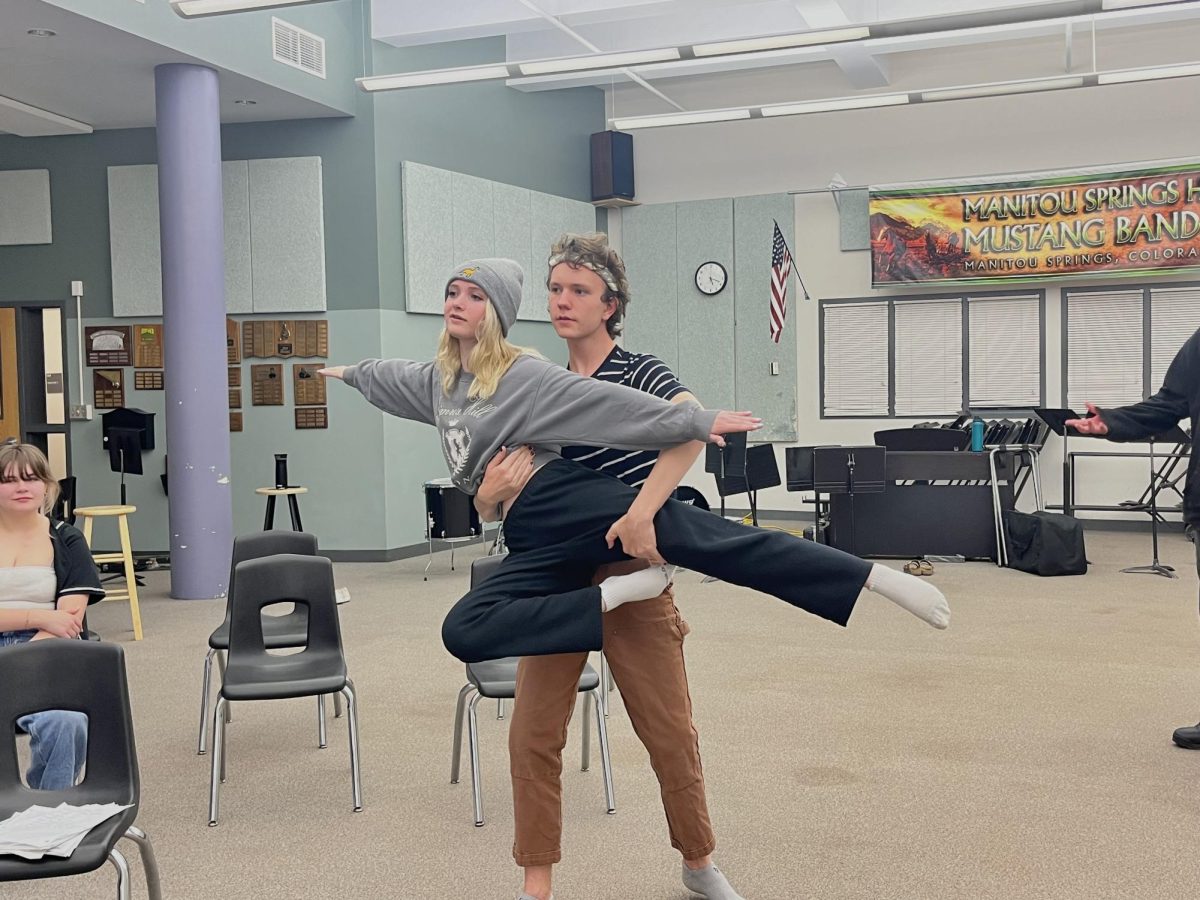 Beckett Wendell-Evans holds Meggan Milliron in the air during a practice dance.