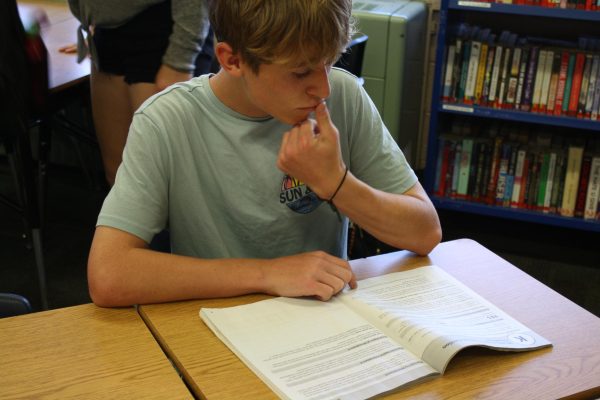 Senior Avery Scott reads over his Blue Book. Blue Books contain information about the election and the measures that are on the ballot.
