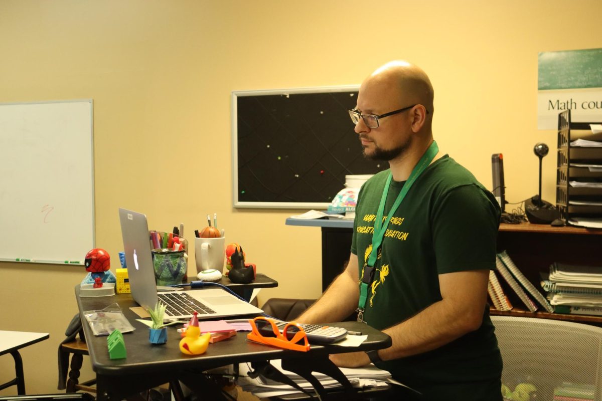 New math and physics teacher Nathaniel Owen works at his standing desk.