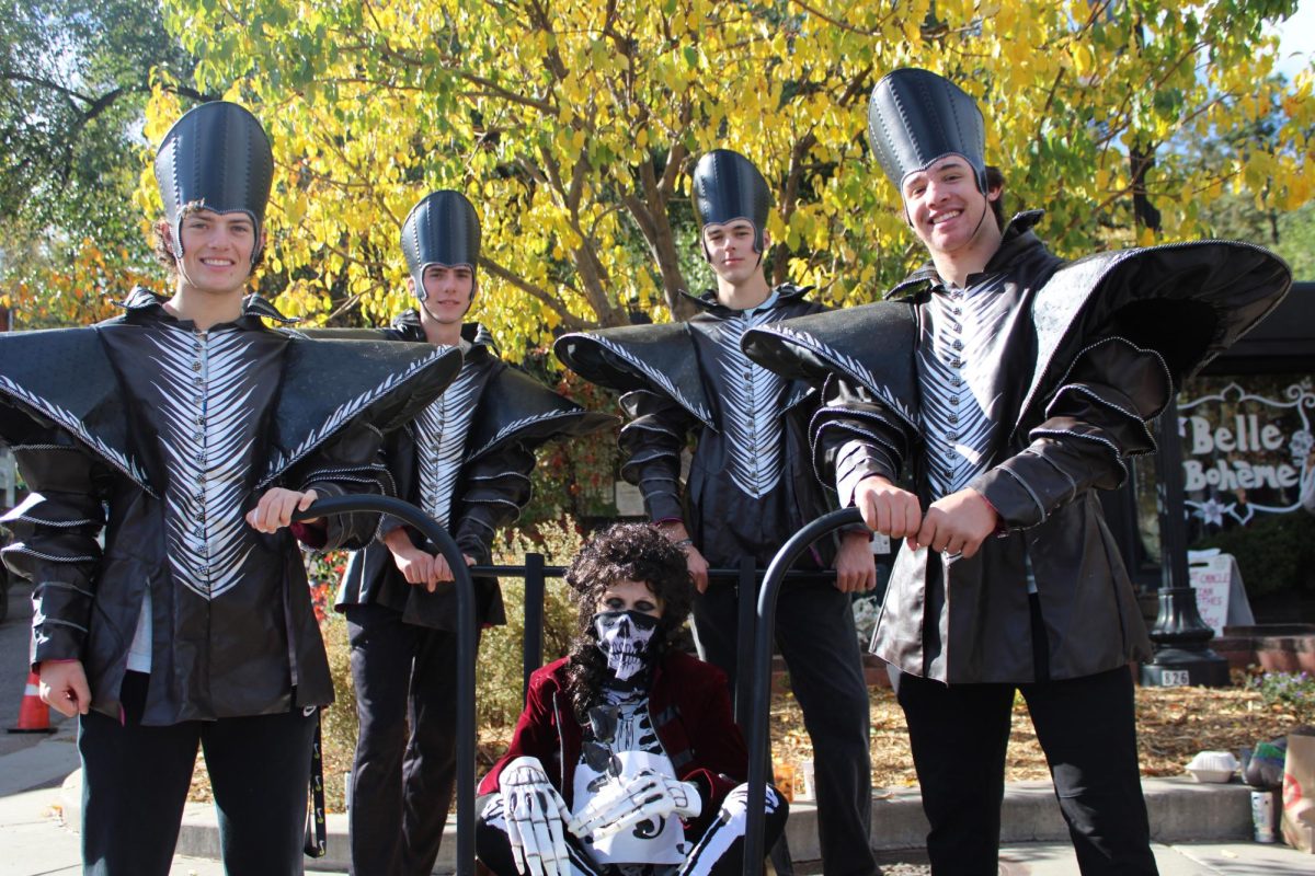 Ethan Traenkle, Fennegan Loftin, Preston Rhodes, and Logan Moore, pose with the Kiwanis Club coffin at the Coffin races.