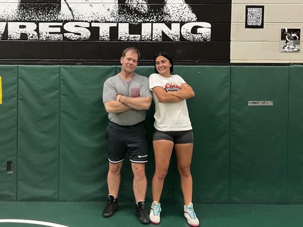 After preseason practice, Coach Paul Bonner and Kara Donegan (12) pose in the wrestling room. 