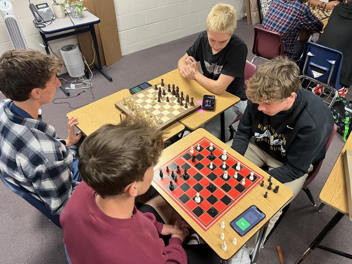 Daniel Parker (11), Braden Legarski (12), Ezra Gervais (11), and Weston Cassidy (11) compete in a game of chess during advisory.