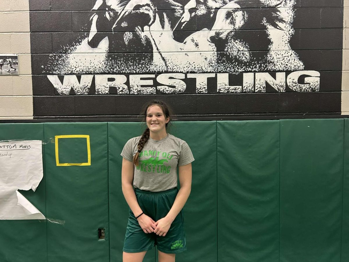 Abbigail Reeves stands at a wall in the wrestling room.