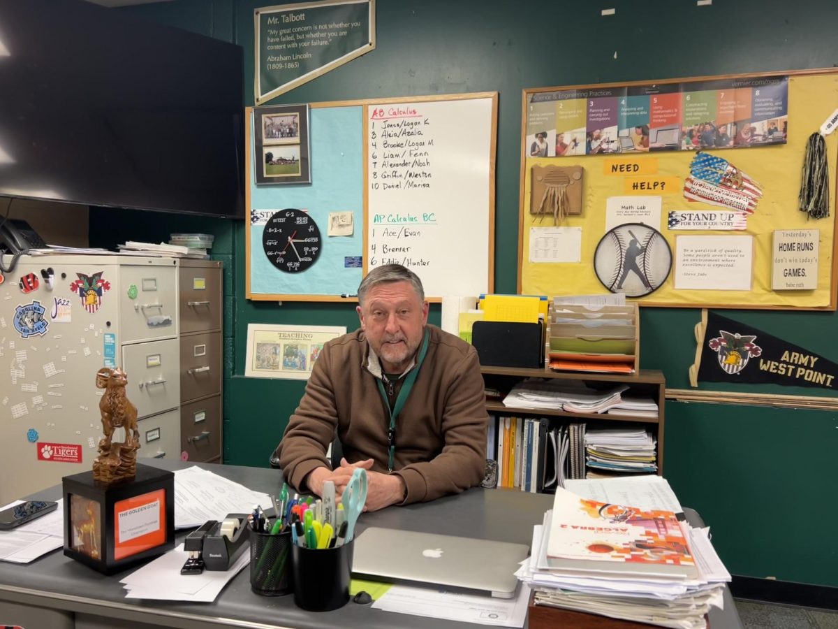 Mike Talbott sits at his desk.