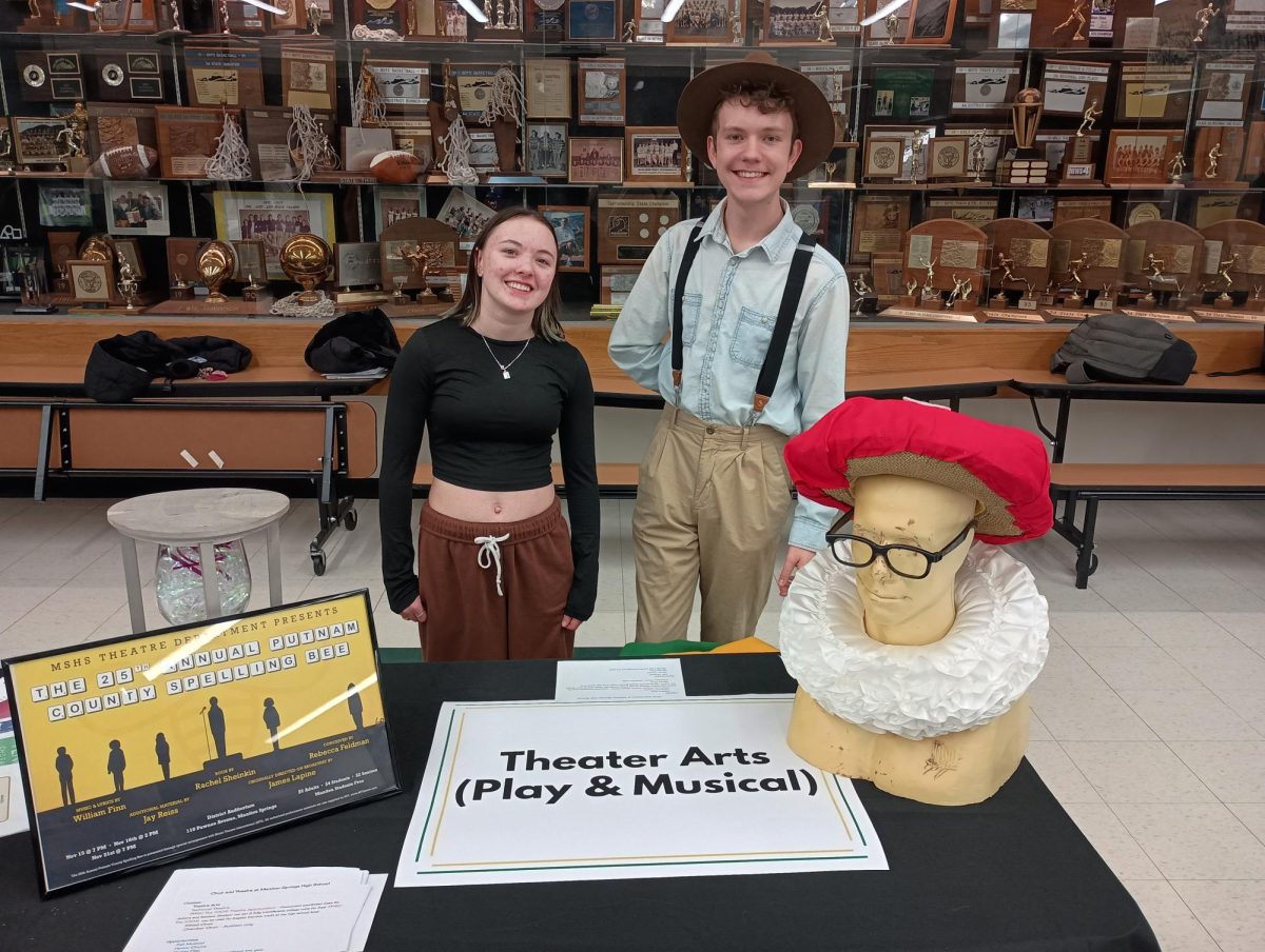 AJ Jackson and Becket Wendell-Evans stand behind the Theater Arts table at welcome night.