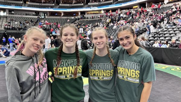 Abbie reeves, Hannah Rickert, Alex Traenkle, and Kara Donagen pose for a photo at a wrestling competition.