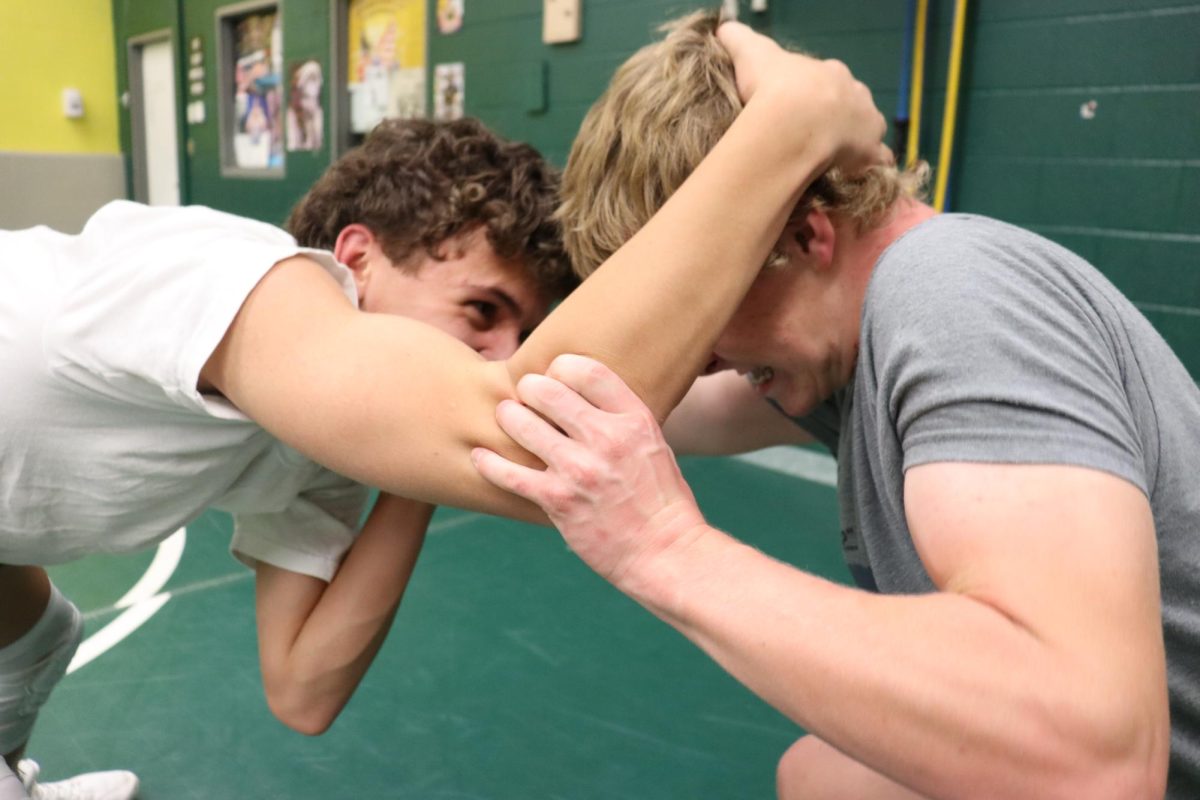 Hunter May (10) and Quinn Morris (11) prepare for this wrestling season on Nov. 5 in the Manitou Springs High School's wrestling room.