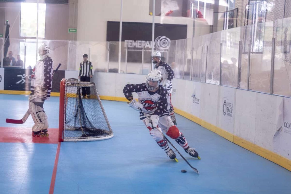 Braylon Greene (11) moves a puck across the ice during the 2025 PanAmerican Games. His team won all five of their games. "He has a unique talent in that he is one of the most consistent youth players I've seen in a long time," his head coach, Nick Boyarsky said. "He always gives you his best game and plays for his team before himself.”