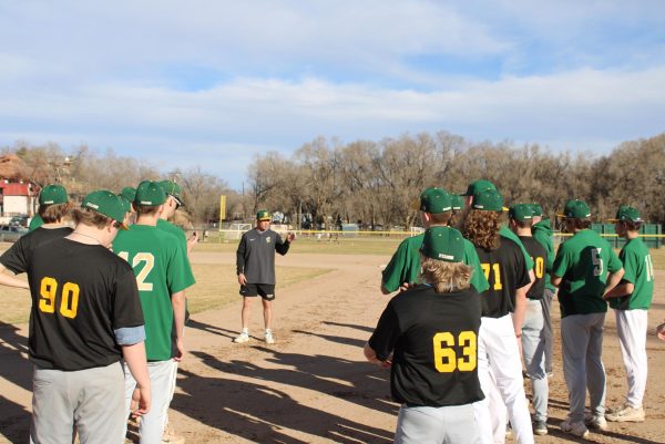 Coach Gregory explains drills at baseball practice.