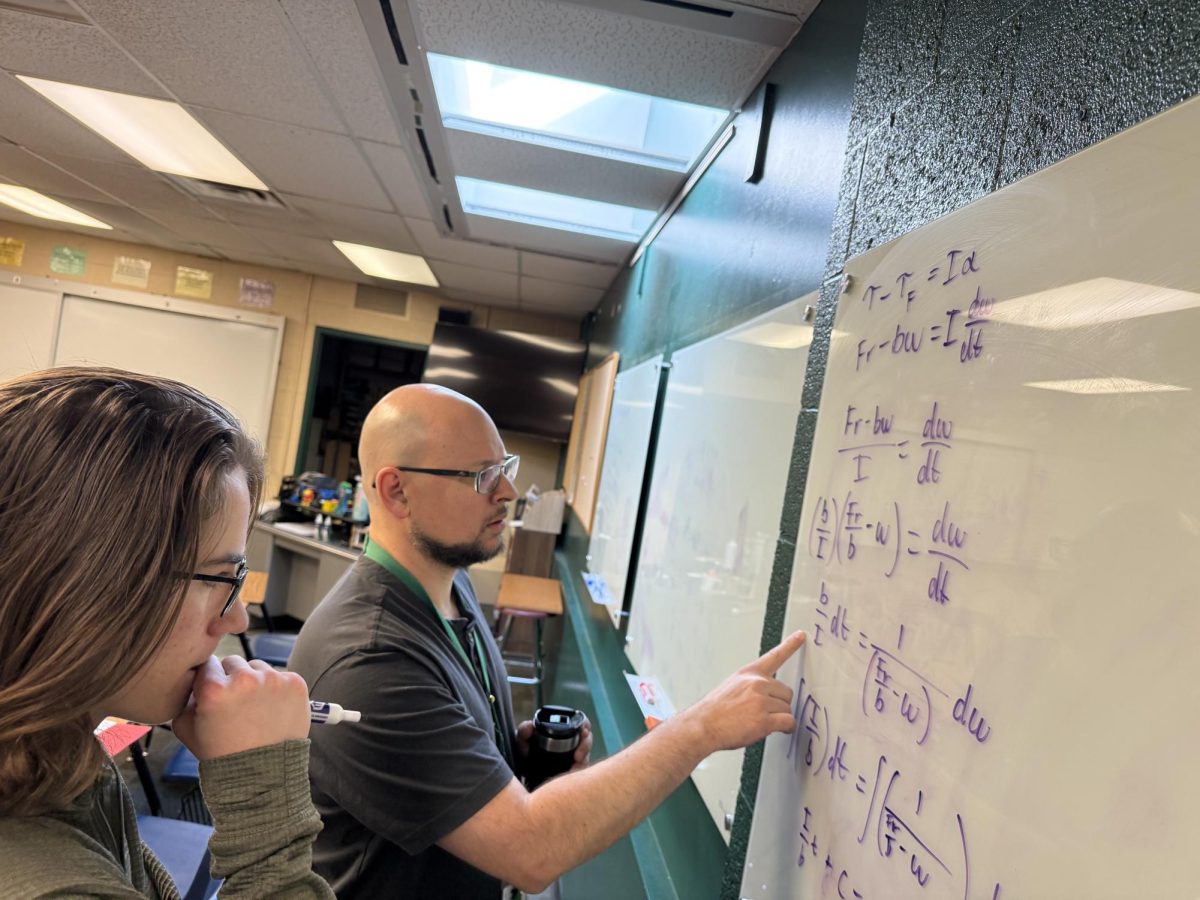Nate Owen helps Quinn Scott (11) with calculus for an upcoming test.