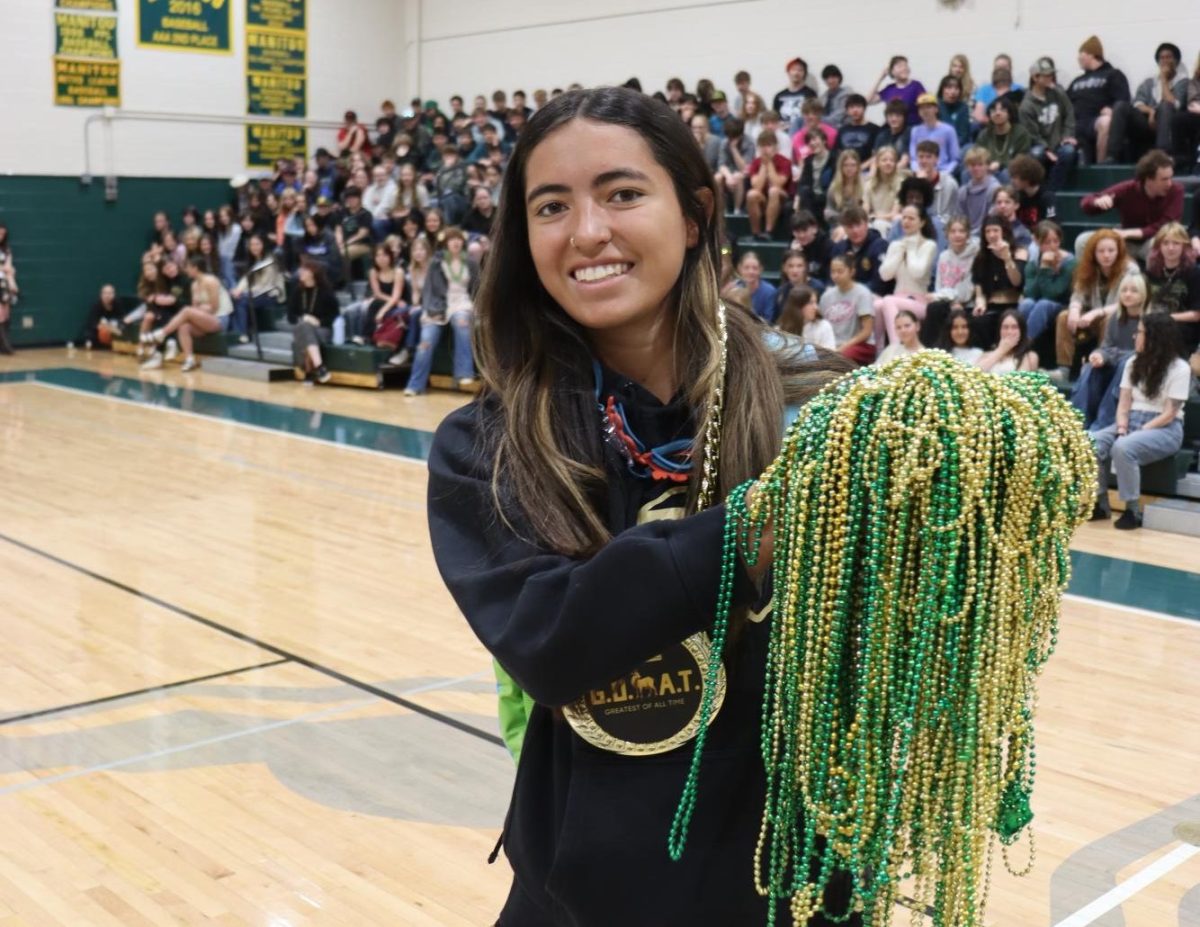 Madison Anderson (12) wins the final Rock Paper Scissors battle and gets a medal and all of the collected beads.