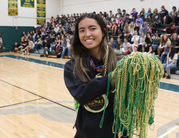 Madison Anderson (12) wins the final Rock Paper Scissors battle and gets a medal and all of the collected beads.